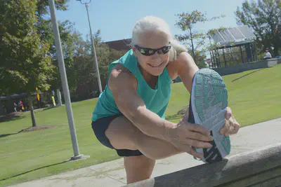 Debbie Dorsey stretches outside the Campus Recreation Center. Photo by Christopher Moore
