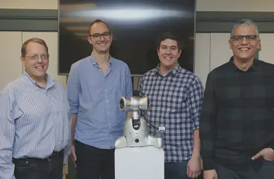 The research team of Shimi stands in front of the newly revamped singing robot. (Left to right) CSE Chair **David Bader, Ph.D.** Student Richard Savery, M.S. student Ryan Rose, GTCMT Director Gil Weinberg stand behind Shimi in the GTCMT lab.