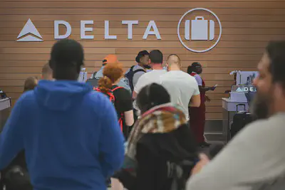 People looking for missing bags wait in line to speak with Delta Air Lines baggage in the Delta Air Lines baggage claim area Los Angeles International Airport (LAX), July 24, 2024, in Los Angeles. Patrick T. Fallon/AFP via Getty Images