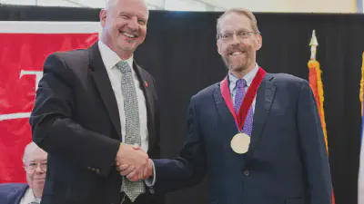 Interim President John Pelesko with Foundation Board of Directors Excellence in Research and Innovation Medal winner David Bader.